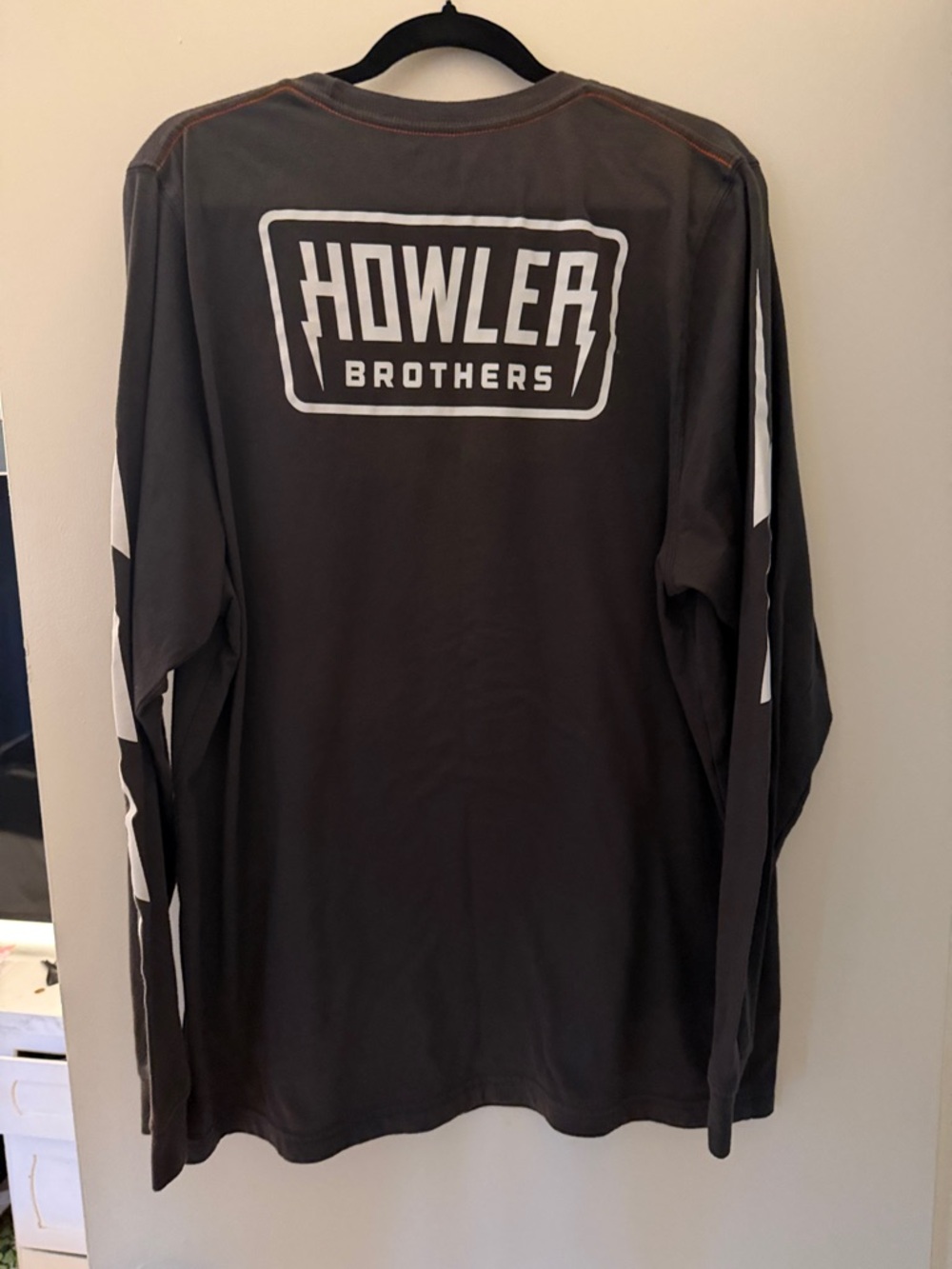 Howler Brothers Black Long Sleeve Tee with White Lightning Bolts on sleeves.